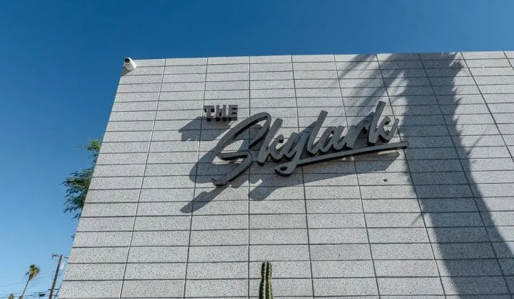 The image shows a building exterior with the sign 